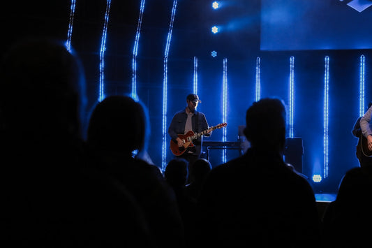 man playing guitar on stage